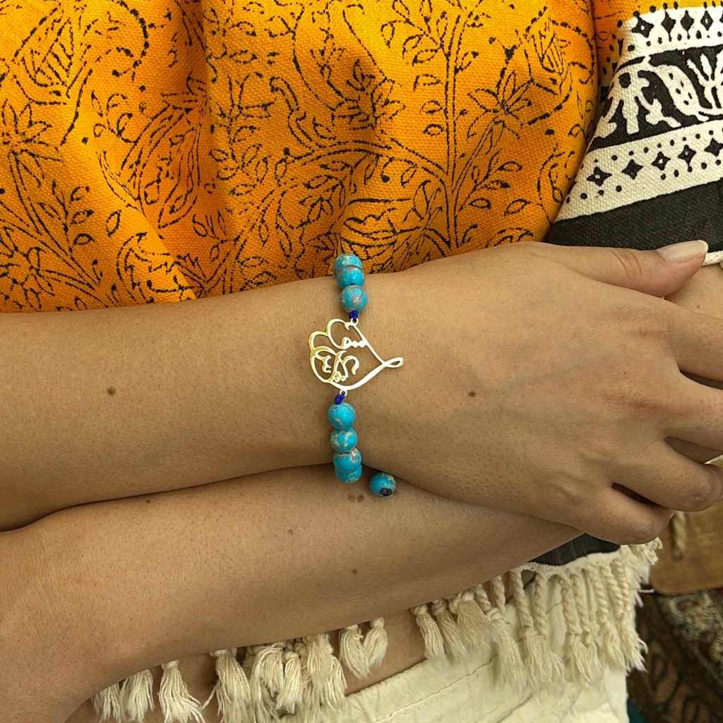 Love Calligraphy Turquoise Bracelet In the hands of the model girl