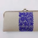 NEEDLEWORK CANVAS CLUTCH, WHITE Handmade structured canvas clutch decorated with needlework inspired by Persian art. Light milky color Size 27 * 13 All-embroidered needlework Fixed color yarn on linen fabric Project Name: Blue Shrub Washable