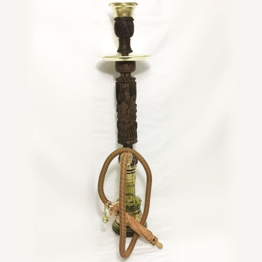 Farvahar Shisha beautifully hand engraved from the finest walnut wood by our artist based in Karaj. The handmade glass base is decorated with hand, gold gilt and enamel painted decoration. Height : 85 cm Material: Walnut wood body, Glass base Style: Persian Shisha Handmade-Persis Collection