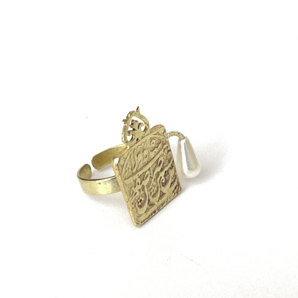 Pearl Ring with Brass Stirrup From a side angle