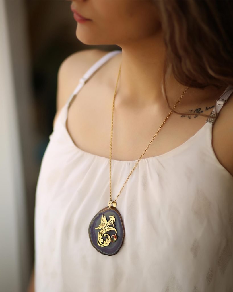 two golden homa birds on Agate Necklace