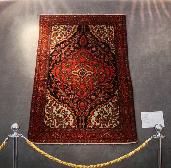 Handwoven Golestan rug with traditional Turkmen patterns and vibrant colors