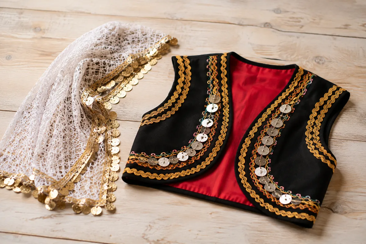 An embroidered vest and headscarf as accent pieces of traditional Persian clothing