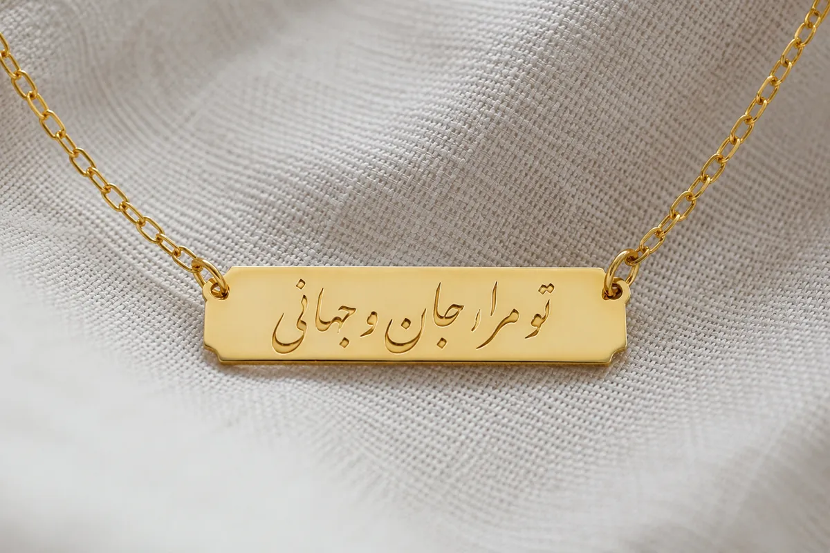 Close up of a Farsi calligraphy name pendant on a fine chain