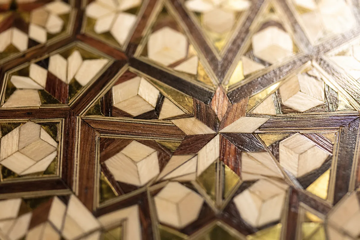 Macro detail of khatam kari marquetry stars on the surface of a Persian backgammon board