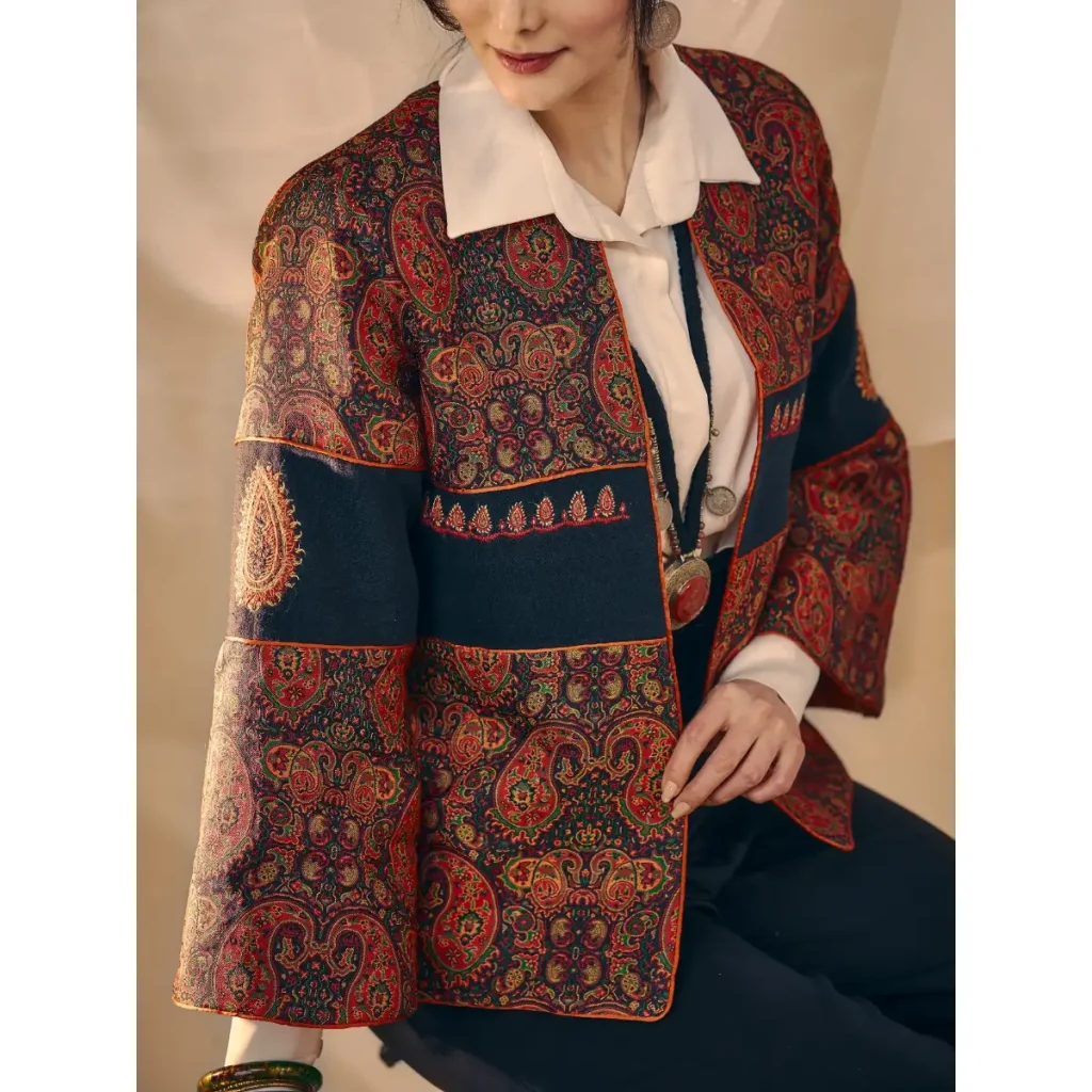 Khatoon Termeh women's coat in red and navy Boteh Jegheh patterned fabric, worn open over a white shirt
