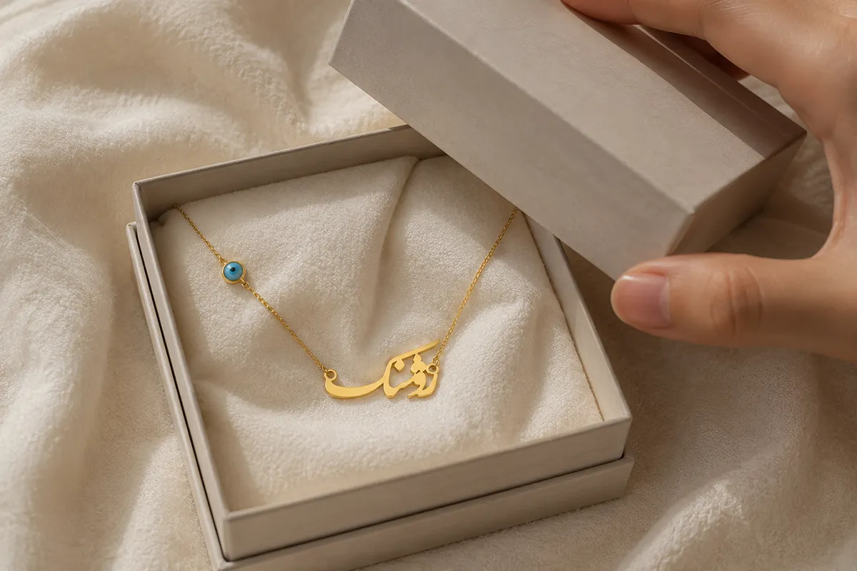 A Persian name necklace in a gift box for a new baby